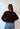 Modell bakfra med BOII Flora Cardigan Dark Brown – myk mørkebrun cardigan med lange ermer og normal, avslappet passform.