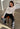 Modell med BOII Fenna Off White – langermet offwhite topp i 100 % bomull med delikat pointelle-mønster og myk struktur.