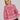 Alt-tekst: Modell med Luxana Knit Pullover Rose/Pink fra A-View – rosa mønstret strikkegenser med rund hals og lange ermer.