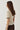 Modell bakfra med N-Marthy Knit Ivory Brown fra Noella – myk ivoryfarget strikkegenser med brune kontrastdetaljer.
