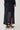 Noella N-Mela Skirt Black – svart paljettskjørt med elastisk linning og glitrende overflate, vist på modell bakfra.