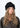 Modell med Jen Harka Hat Black fra Sui Ava – sort hatt i semsket lammeskinn med myk, matt overflate.