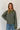Stripete strikket polo fra Boii i Olive/Blue, laget i 100 % bomull med polokrage, lange ermer og oversized passform i One Size. Modellen er 174 cm høy.