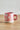 Millie Espresso Cup Multi fra Bloomingville – rosa espressokopp i steintøy med hvitt blomstermønster, stylet på trebord.