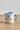 Millie Espresso Cup Blue Croissant fra Bloomingville MINI – lyseblå espressokopp i steintøy med håndmalte croissanter.