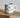 Millie Espresso Cup Blue Croissant 110 ml fra Bloomingville MINI – lyseblå kopp med oransje croissantmotiv og beige bunn.