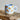 Millie Espresso Cup Blue Croissant 110 ml fra Bloomingville MINI – lyseblå kopp med oransje croissantmotiv og beige bunn.