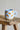 Millie Espresso Cup Blue Croissant 110 ml fra Bloomingville MINI – lyseblå kopp med oransje croissantmotiv og beige bunn.