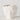 Hvit skulpturell vase i porselen med preget ansiktsmotiv. Glanset overflate og moderne design.