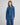 Modell med Ago Rue Denim Shirt fra MSCH Copenhagen i mellomblå denim med rynkedetaljer og trykknapper.