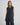 Modell med MSCHBondie Hope Vest fra MSCH Copenhagen – svartmelert strikkevest med rund hals og knappelukking foran.