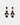 Aria Earrings Brown fra Bow19 med fasettslepne brune krystaller og mørk blank kule i gullfarget innfatning.